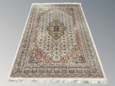 A Tabriz rug, 220 cm x 146 cm.