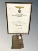 A reproduction German skull ring, a ceramic stopper with SS runes, a Soldbuch and a print in frame.