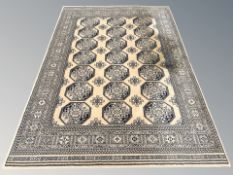A machine made rug of Bokhara design, 233 cm x 160 cm.