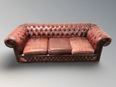 A Chesterfield oxblood leather three seater club settee,