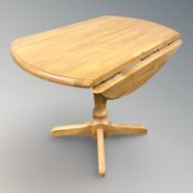 A modern pine dropleaf table, width 91 cm.