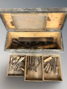 An antique pine joiner's toolbox containing woodworking tools.