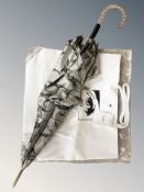 A Calvin Klein shoulder bag and a silk umbrella