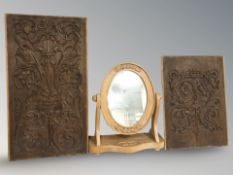 Two carved oak relief panels, largest 71 cm x 39 cm, and a carved pine dressing table mirror.