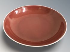 A Chinese sang de boeuf glazed circular dish, Daoguang reign mark in underglaze blue but modern,