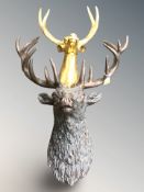A bronze effect resin stag's head, height 82 cm, and a further gilt resin stag's head.