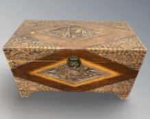 An oriental heavily carved camphor wood blanket chest, width 104 cm.