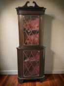 A 19th century mahogany and satinwood banded corner cabinet, height 230 cm.
