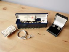 A group of jewellery comprising silver belt form bracelet, two silver dress rings,