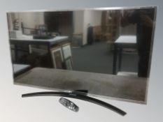 A LG 43 inch LCD TV with lead and remote