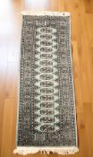A Lahore Bokhara runner, Pakistan, 201 cm x 62 cm.