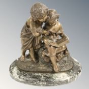 A 20th century patinated bronze figure group of two children reading on variegated marble plinth,