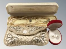 A lady's evening bag decorated with pearls, a Lotus box containing pearl necklaces,