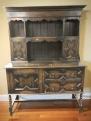 A panelled oak dresser in the 17th century style, 138 cm x 53 cm x 190 cm.