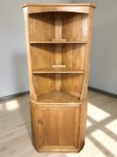 An Ercol light elm standing corner cabinet, height 179 cm.