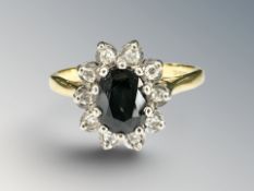 An 18ct yellow gold sapphire and diamond cluster ring. CONDITION REPORT: 4.3g.