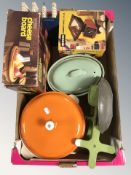 A group of enameled kitchen wares, set of scales, cheese board in box.
