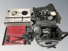 An Olympus E520 digital camera, with 14-42mm lens, a Pentax camera,