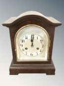 A Junghans mantel clock, with pendulum, striking on a gong, height 29 cm.