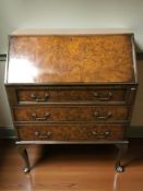 A figured walnut lady's writing bureau, 77 cm x 41 cm x 102 cm.