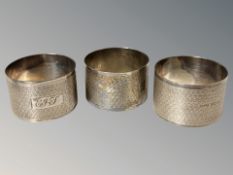A set of three silver napkin rings with engine turned decoration.