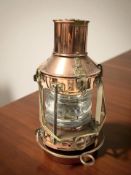 A copper and brass ship's lamp, height 33 cm including handle.