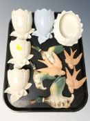 Two graduated sets of ceramic flying bird ornaments and a group of wall pockets.