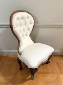 A mahogany lady's salon chair in buttoned cream upholstery.