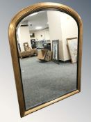A Victorian style gilt and ebonised domed mirror, 87 cm x 112 cm.