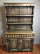 A reproduction oak dresser, 107 cm x 45 cm x 179 cm.