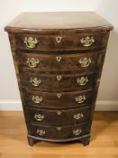 A George III style figured walnut bow front six drawer chest, 48 cm x 40 cm x 91 cm.