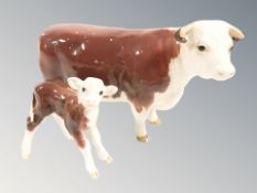 A Beswick cow CH of champions, length 17.5 cm, and a similar calf.