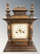 A Victorian stained beech eight day mantel clock, striking on a gong, with pendulum, height 37 cm.