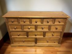A modern pine fourteen drawer chest, 137 cm x 40 cm x 91 cm.