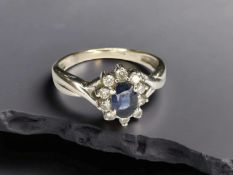 An 18ct white gold sapphire and diamond ring, size P CONDITION REPORT: 4.