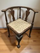 A mahogany corner armchair.
