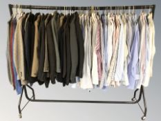 A rail of gent's blazers, dress shirts, jumpers, etc.