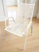 A Scandinavian enameled metal framed armchair with sling seat.