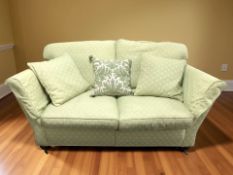 A Duresta Ruskin Victorian style three seater settee in green upholstery,