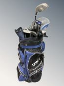 An onyx golf bag containing assorted irons and drivers including Wizard, Wilson, etc.