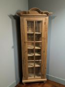 A modern pine glazed single door cabinet, with shelved interior and key, 78 cm x 38 cm x 196 cm.