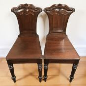 A pair of Victorian mahogany hall chairs, width 38 cm.