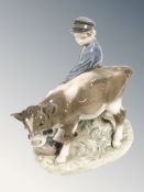 A Royal Copenhagen figure of a boy and a calf, number 772.