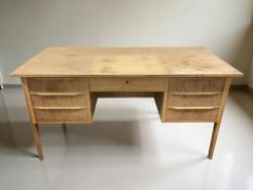 A 20th century Danish faded teak twin pedestal desk, 137 cm x 69 cm x 72 cm.