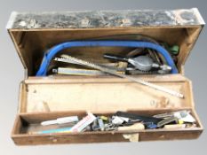 A pine joiner's toolbox containing hand tools.