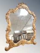 A reproduction carved pine wall mirror, 122 cm x 91 cm.