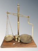 A mahogany and brass scale by W & T Avery Limited, with two weights, height 64 cm.
