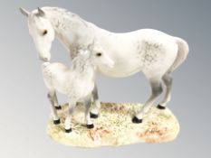 A Beswick group of a dappled grey horse and foal, length 22 cm.