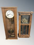 An early 20th century oak wall clock with pendulum, weights and key, height 82 cm,