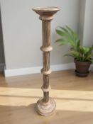 A contemporary painted and gilt torchere, height 126 cm.